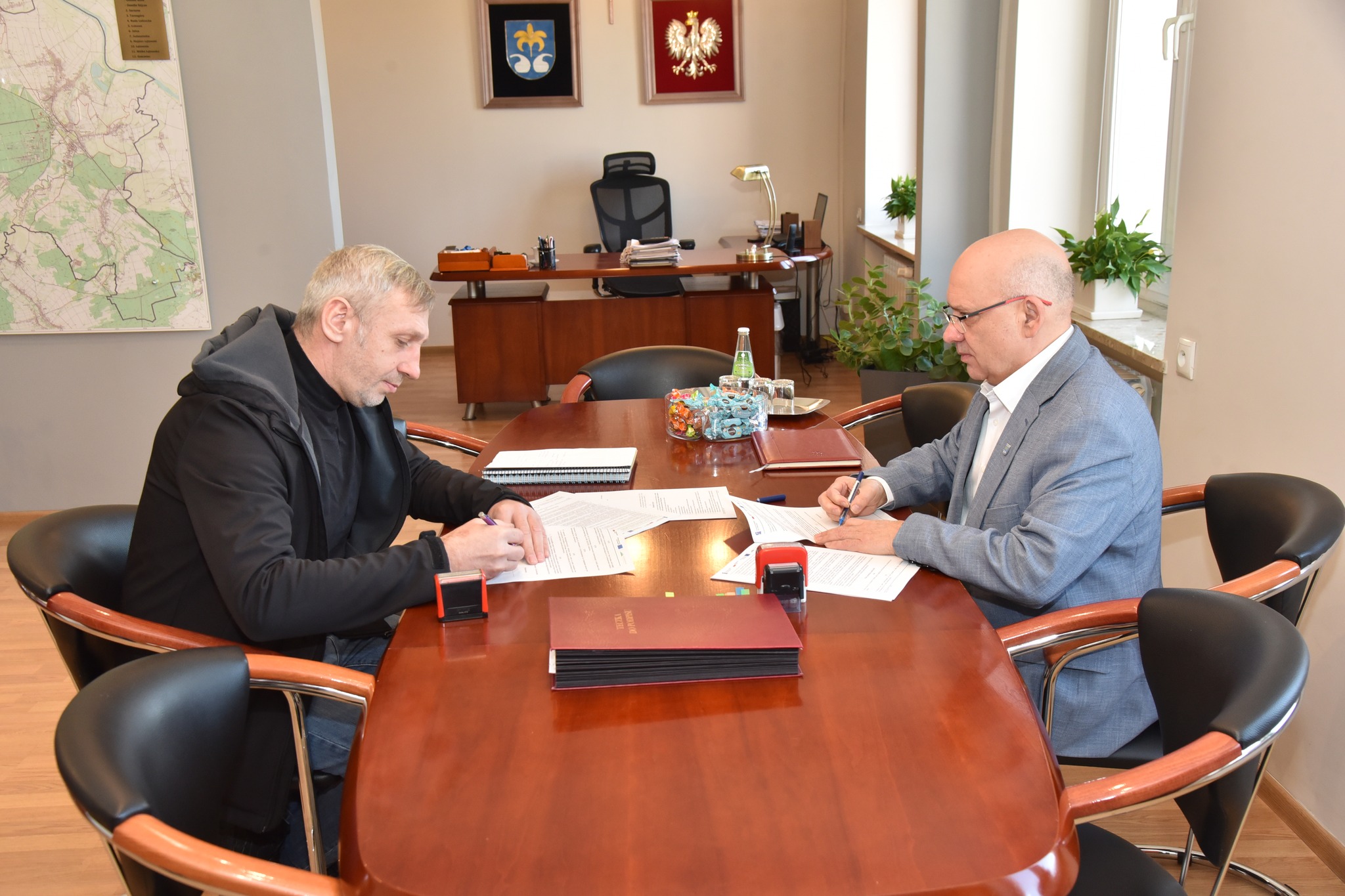 zdjęcie przedstawia podpisanie umowy przez burmistrza Andrzeja Rychla oraz&nbsp;Sławomira Barana, reprezentującego wykonawcę &ndash; firmę &bdquo;Usługi Koparką&rdquo; z&nbsp;Przewrotnego w&nbsp;gabinecie Burmistrza Urzędu Miasta i&nbsp;Gminy w&nbsp;Nowej Sarzynie