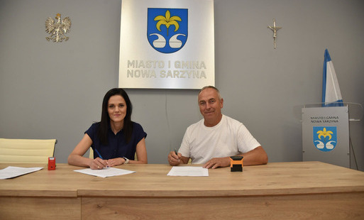 zdjęcie przedstawia moment podpisania umowy przez Dyrektor Centrum Kultury i Biblioteki Emilia Wojtyna z Tadeuszem Pielą, przedstawicielem firmy REM-BUD z Łętowni
